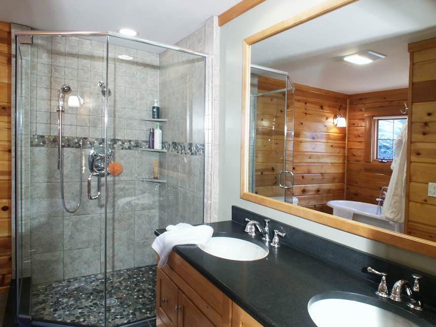 glass shower and sink with granite countertop