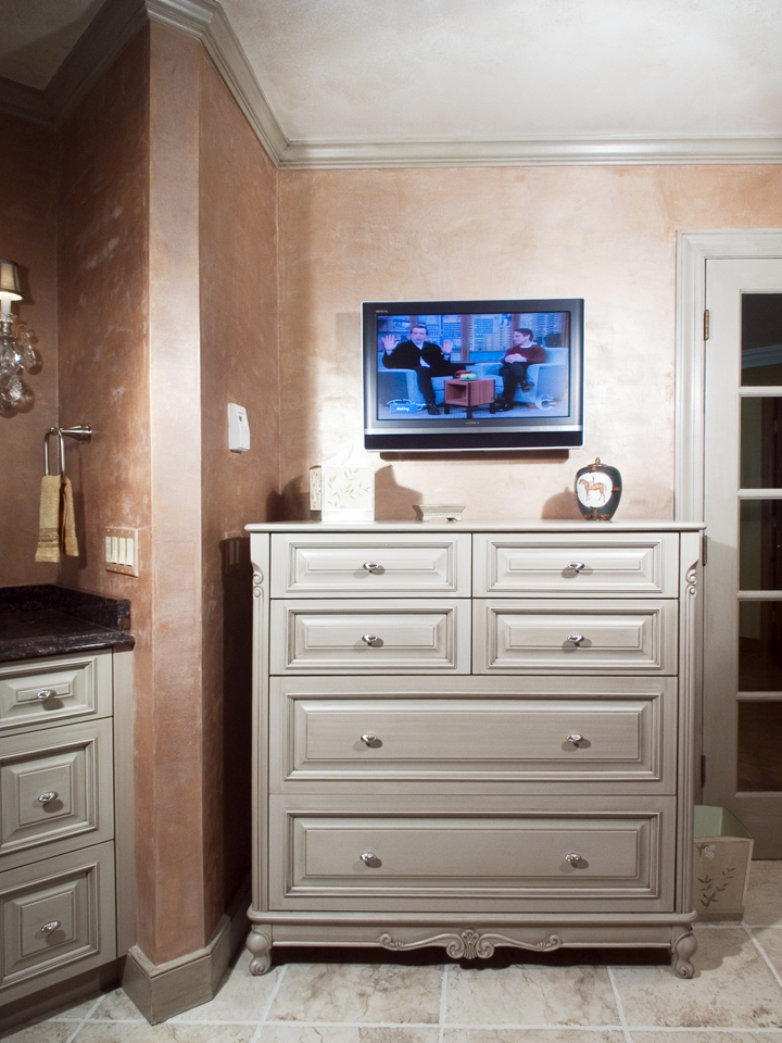 Bathroom with cabinetry and television