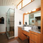 Contemporary bathroom with natural wood cabinetry and glass shower Coopersburg, PA