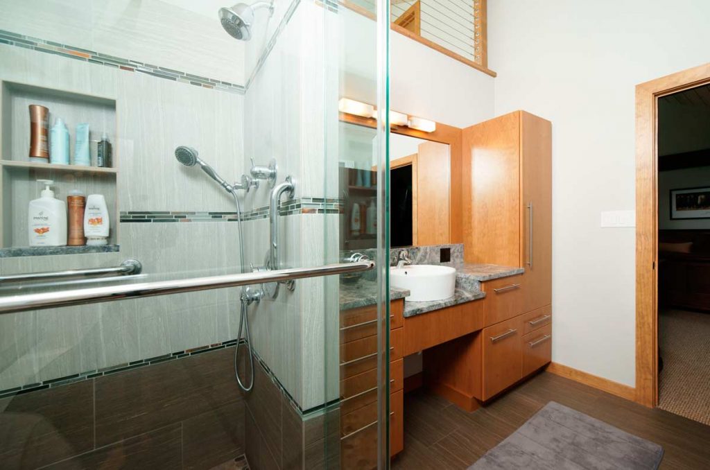 Contemporary bathroom with glass shower and natural wood cabinetry Coopersburg, PA