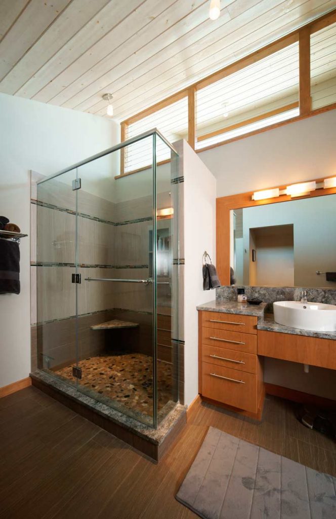 Glass shower in contemporary bathroom with natural wood cabinetry Coopersburg, PA