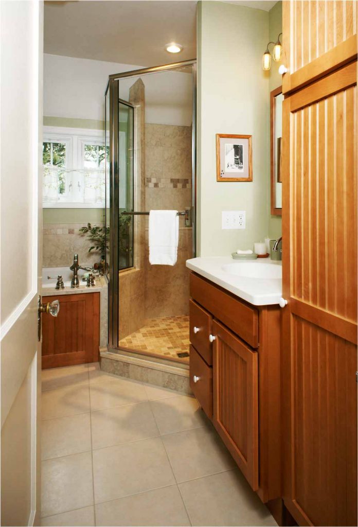 Stained maple cabinetry next to glass shower Bethlehem, PA