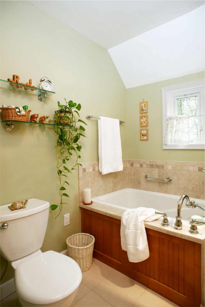 Drop-in bathtub in stained maple surround next to toilet Bethlehem, PA