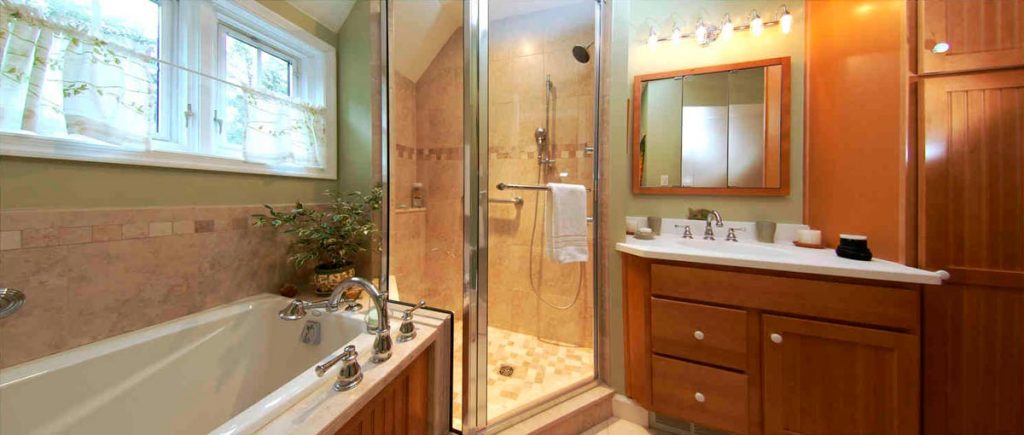 Bathroom with stained maple cabinetry and bathtub next to a shower Bethlehem, PA