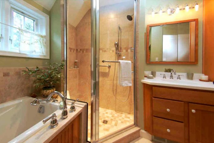 Bathroom with stained maple cabinetry and bathtub next to a shower Bethlehem, PA