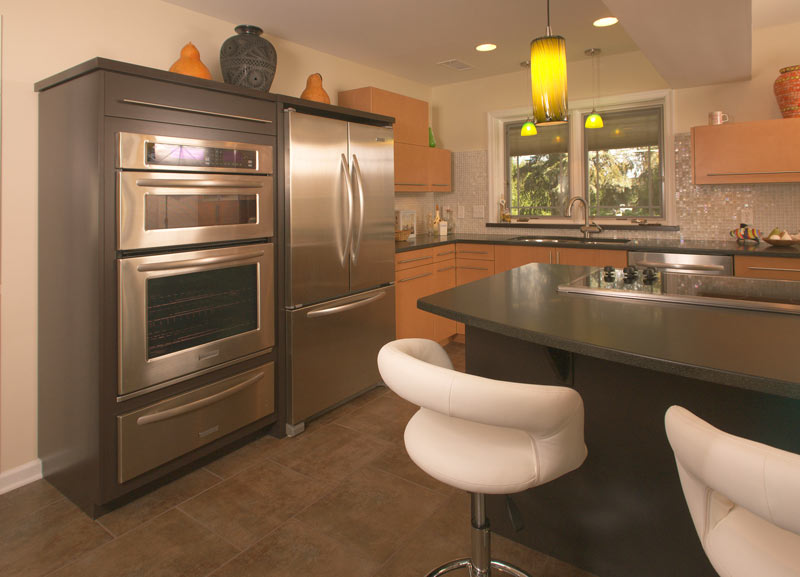 large contemporary kitchen with granite counter tops and double wall ovens designed by morris black designs