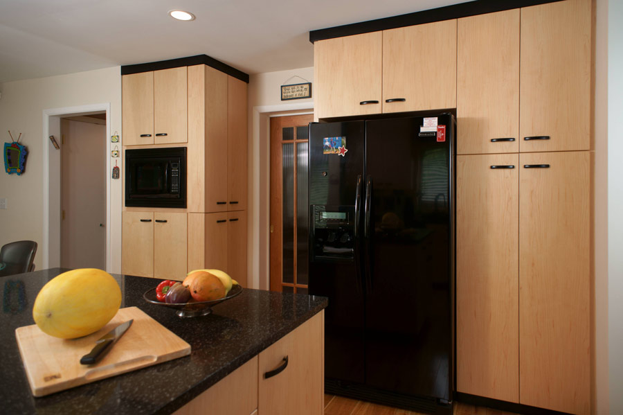 this award winning kitchen includes contemporary veneered maple cabinets and plenty of storage space