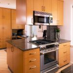 a stainless jennair range is located in the island of this contemporary maple kitchen in Philadelphia