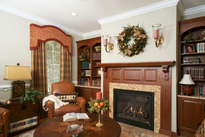 Parlor with bookshelves, low round table, chairs, and fireplace Allentown, PA
