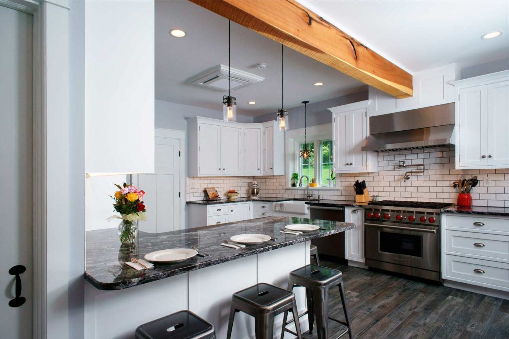 The stainless steel appliances, pendant lights, and granite countertops