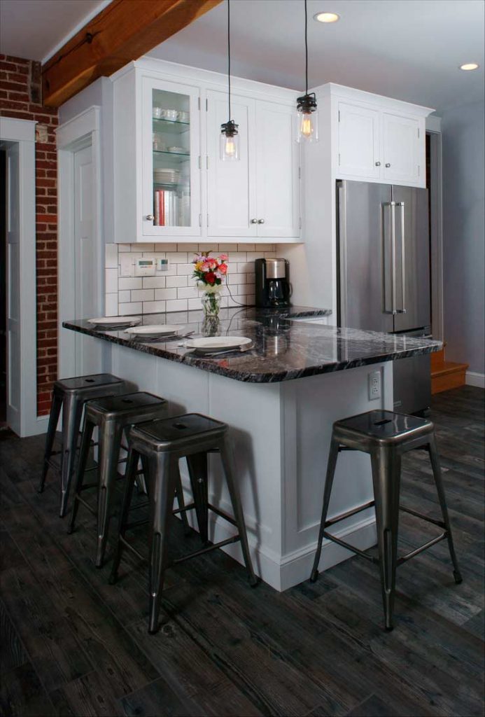 stunning traditional white kitchen in Allentown Pennsylvania with granite peninsula eat in area and bar stools