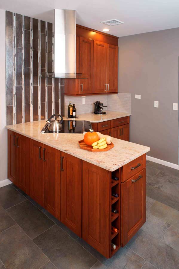 transitional cherry kitchen renovation in Bethlehem Pennsylvania with corner style range and range hood, morris black