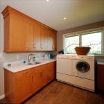 laundry room with washer, dryer, undermount sink, and light wood cabinetry Allentown, PA