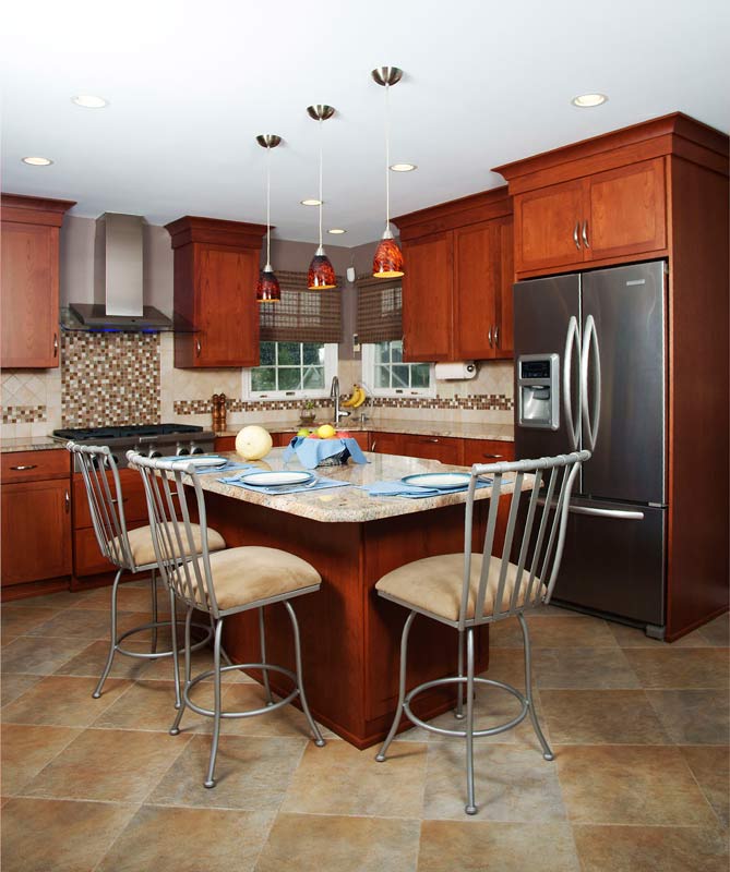 transitional open cherry kitchen with shaker style doors and stainless steel appliances along with counter seating