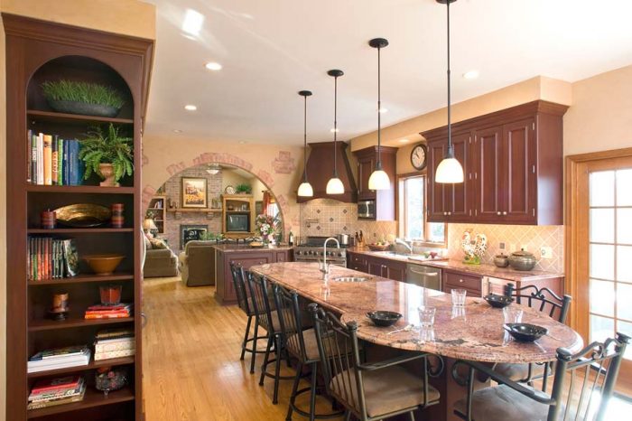 large kitchen island with ample seating and lighting in a mediterranean kitchen