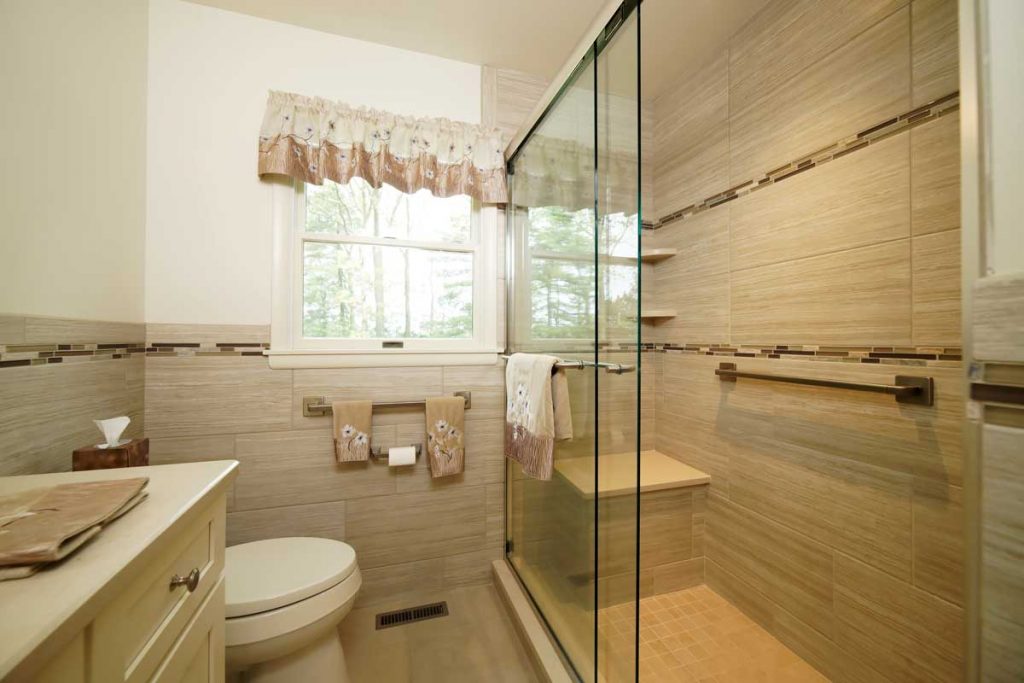 shaker style bathroom with a glass door shower and white vanity