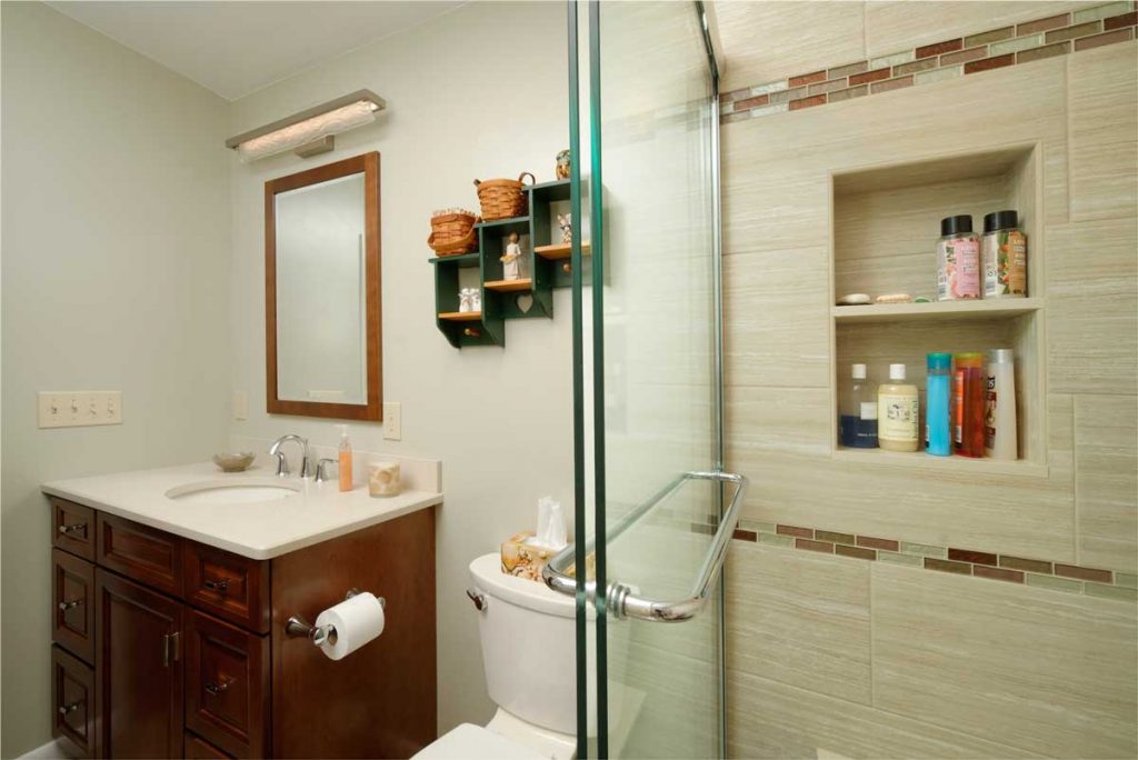 traditional bathroom design with a tile shower and single wood vanity in bethlehem pa