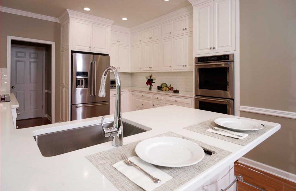 white kitchen cabinets with white countertops in a traditional kitchen