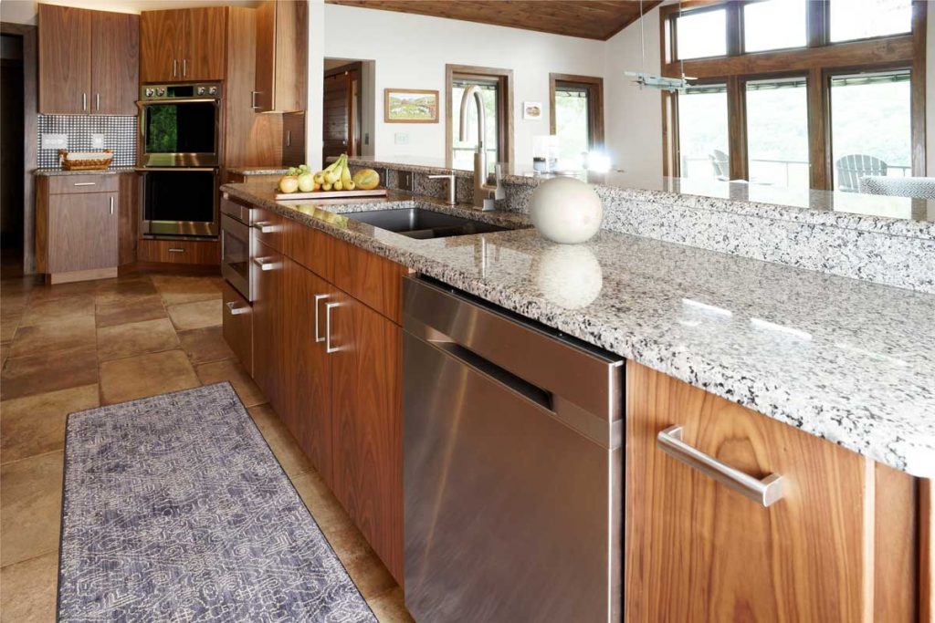 contemporary stone kitchen with a granite countertop and walnut cabinetry
