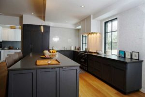 Contemporary Kitchen with Dark Base Cabinets and White Walls