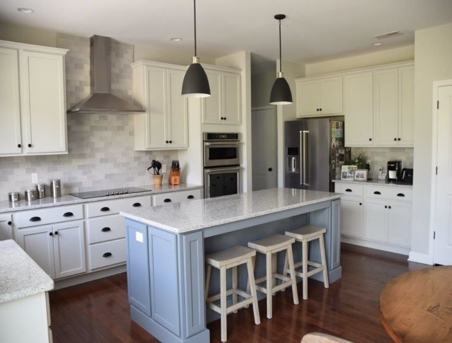 Bring warmth to your white cabinetry with a green or blue island