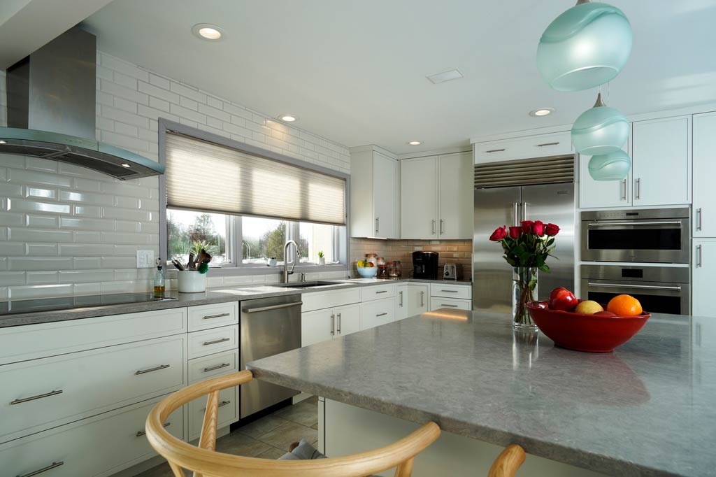 White Kitchen with White Backsplash and Stainless Steel Appliances